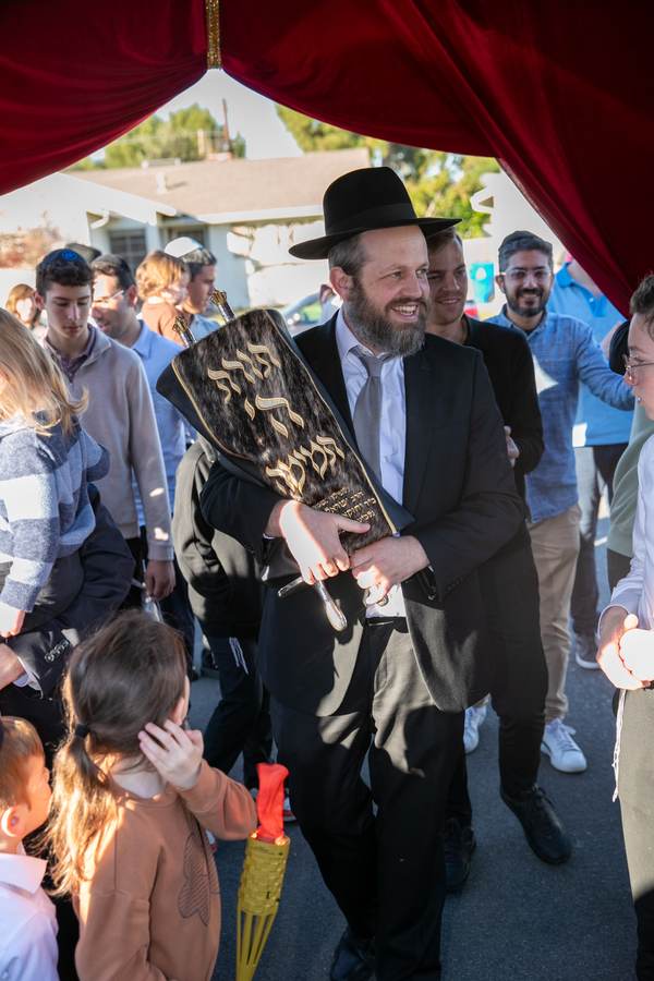 Boys walking with the Sefer Torah under the chuppah